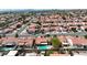 Expansive aerial view of a neighborhood featuring homes with red tile roofs and some with refreshing backyard pools at 608 Blooming View Ave, North Las Vegas, NV 89032