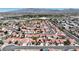Extensive aerial view of a community featuring homes with distinctive red tile roofs amid desert landscaping at 608 Blooming View Ave, North Las Vegas, NV 89032