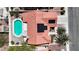 Bird's eye view of home with a sparkling blue pool, solar panels, covered patio and desert landscaping at 608 Blooming View Ave, North Las Vegas, NV 89032