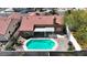 Aerial view of a backyard featuring a sparkling pool and patio with tiled roof at 608 Blooming View Ave, North Las Vegas, NV 89032