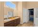 Bathroom featuring double sinks with granite countertops, tile floors, and a walk-in shower at 608 Blooming View Ave, North Las Vegas, NV 89032