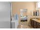 Bright bathroom featuring tiled countertops, step in shower and access to a large bright bedroom at 608 Blooming View Ave, North Las Vegas, NV 89032