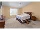 Bedroom with a queen bed, large window, neutral carpet, and dual bedside tables at 608 Blooming View Ave, North Las Vegas, NV 89032