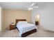 Bedroom with a queen bed, ceiling fan, neutral carpet, and an ensuite bathroom at 608 Blooming View Ave, North Las Vegas, NV 89032