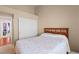 Comfortable bedroom with neutral tones, a cozy bed, and closet at 608 Blooming View Ave, North Las Vegas, NV 89032
