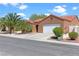 Single-story home featuring a terracotta roof, palm trees, an attached two-car garage, and well-maintained landscaping at 608 Blooming View Ave, North Las Vegas, NV 89032