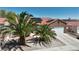 Charming single story home featuring desert landscaping, tile roof, two-car garage, and solar panels at 608 Blooming View Ave, North Las Vegas, NV 89032