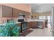 Well-lit kitchen with stainless steel appliances, tile flooring, and view to the pool and living area at 608 Blooming View Ave, North Las Vegas, NV 89032