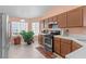 Well-lit kitchen with stainless steel appliances, tile flooring, and neutral-colored cabinetry at 608 Blooming View Ave, North Las Vegas, NV 89032