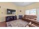 Cozy living room featuring a fireplace, large TV, and comfortable seating arrangement at 608 Blooming View Ave, North Las Vegas, NV 89032