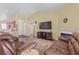 Inviting living room with vaulted ceilings, fireplace, and comfortable leather seating at 608 Blooming View Ave, North Las Vegas, NV 89032