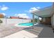 A private in-ground pool and covered patio create an inviting outdoor living space, enclosed by a white block wall at 608 Blooming View Ave, North Las Vegas, NV 89032