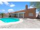 A private in-ground pool and covered patio create an inviting outdoor living space, enclosed by a white block wall at 608 Blooming View Ave, North Las Vegas, NV 89032