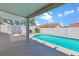 A private in-ground pool and covered patio create an inviting outdoor living space, enclosed by a white block wall at 608 Blooming View Ave, North Las Vegas, NV 89032