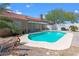 A private in-ground pool and covered patio create an inviting outdoor living space with lush tropical foliage at 608 Blooming View Ave, North Las Vegas, NV 89032