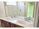 Bathroom featuring a double vanity, tiled floors, and a glass-enclosed shower at 6339 Sharp Rock Ct, Las Vegas, NV 89139