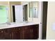 Bathroom with double sinks, wood cabinets, and neutral paint at 6339 Sharp Rock Ct, Las Vegas, NV 89139