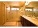Bright bathroom featuring double vanity, framed mirror, and walk-in shower with glass door at 6339 Sharp Rock Ct, Las Vegas, NV 89139