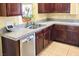 A sink area in the kitchen with wood cabinets and stainless steel appliances at 6339 Sharp Rock Ct, Las Vegas, NV 89139