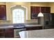 Well-lit kitchen offering stainless steel appliances, granite counters and custom cabinets at 6339 Sharp Rock Ct, Las Vegas, NV 89139