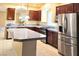 Bright kitchen featuring an island, stainless steel appliances and custom cabinetry at 6339 Sharp Rock Ct, Las Vegas, NV 89139