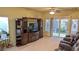 Entertainment center and sliding glass door and seating in open living room at 6339 Sharp Rock Ct, Las Vegas, NV 89139