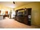Living room with entertainment center, open floor plan flowing into the kitchen at 6339 Sharp Rock Ct, Las Vegas, NV 89139
