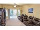 Cozy living room featuring three brown leather recliners facing a sliding glass door to the backyard at 6339 Sharp Rock Ct, Las Vegas, NV 89139