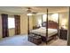 Comfortable bedroom featuring a four-poster bed with bedside tables, dresser, and a window at 6339 Sharp Rock Ct, Las Vegas, NV 89139