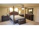 Beautiful main bedroom with a four-poster bed, carpet, and decorative mirror over dresser at 6339 Sharp Rock Ct, Las Vegas, NV 89139