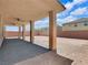 Covered patio with brick pavers overlooking a spacious backyard ready for landscaping at 6465 Grande River Ct, Las Vegas, NV 89139