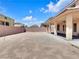 Expansive backyard featuring a covered patio and block wall, ready for customization at 6465 Grande River Ct, Las Vegas, NV 89139