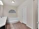 Bright bathroom with double sinks, soaking tub, and dark wood cabinetry at 6465 Grande River Ct, Las Vegas, NV 89139