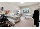 Comfortable bedroom features plush carpet, white furniture, and ample natural light at 6465 Grande River Ct, Las Vegas, NV 89139