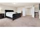 This primary bedroom features a King bed, plush carpet, and double doors to the primary bath and closet at 6465 Grande River Ct, Las Vegas, NV 89139