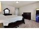 Comfortable bedroom featuring a large bed, dark wood furniture, and neutral decor at 6465 Grande River Ct, Las Vegas, NV 89139
