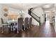 Formal dining room with a decorative chandelier, wood floors, and staircase to the second floor at 6465 Grande River Ct, Las Vegas, NV 89139