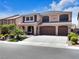 Elegant two-story home with a three-car garage and well-maintained landscaping, offering curb appeal at 6465 Grande River Ct, Las Vegas, NV 89139