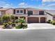 Charming two-story home with a three-car garage, desert landscaping, and a paved driveway at 6465 Grande River Ct, Las Vegas, NV 89139