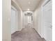 Neutral hallway featuring 3 white doors and plush carpet, creating a serene and inviting atmosphere at 6465 Grande River Ct, Las Vegas, NV 89139