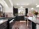 Modern kitchen featuring stainless steel appliances, granite countertops, and wood-look tile flooring at 6465 Grande River Ct, Las Vegas, NV 89139