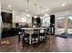 Well-lit kitchen with dark cabinetry, granite countertops, an island with seating, and a view of the backyard at 6465 Grande River Ct, Las Vegas, NV 89139