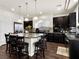 Modern kitchen with granite countertops, stainless steel appliances, and a large center island with seating at 6465 Grande River Ct, Las Vegas, NV 89139