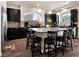Modern kitchen with granite countertops, stainless steel appliances, and a large center island with seating at 6465 Grande River Ct, Las Vegas, NV 89139