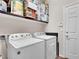 Practical laundry room featuring a washer, dryer, and convenient overhead storage at 6465 Grande River Ct, Las Vegas, NV 89139