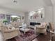 Elegant living room featuring a fireplace, decorative rug, and large windows offering ample natural light at 6465 Grande River Ct, Las Vegas, NV 89139
