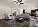 Open concept living room with hardwood floors, ceiling fan, and view to kitchen at 6465 Grande River Ct, Las Vegas, NV 89139
