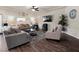 Modern living room featuring tile floors, comfortable seating, and a television for entertaining at 6465 Grande River Ct, Las Vegas, NV 89139