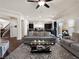 Spacious living room featuring modern furniture and a view of the open-concept kitchen at 6465 Grande River Ct, Las Vegas, NV 89139