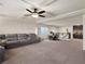 An expansive loft is equipped with a ceiling fan, recessed lighting, and a sleek black metal railing at 6465 Grande River Ct, Las Vegas, NV 89139